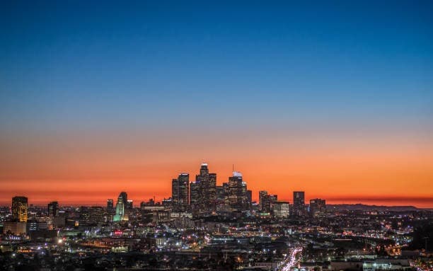An urban skyline at dusk representing the business environments served by Nevens Consulting EA.
